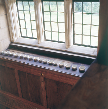 Fig 2. Edmund de Waal, ‘A line in the sand’,  installation of 20 pots for high ledge, porcelain with Shino glaze 2002, photographer Graham Murrel/ courtesy of Lakeland Trust.