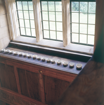 Fig 2. Edmund de Waal, ‘A line in the sand’, installation of 20 pots for high ledge, porcelain with Shino glaze 2002, photographer Graham Murrel/ courtesy of Lakeland Trust.